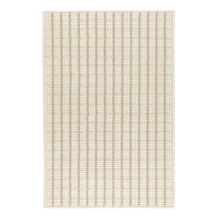 a beige and white checkered rug on a white background with no one in it