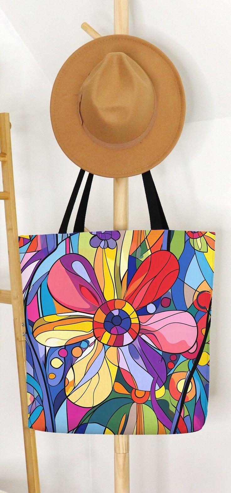 a hat is hanging on the wall next to a bag with an abstract flower design