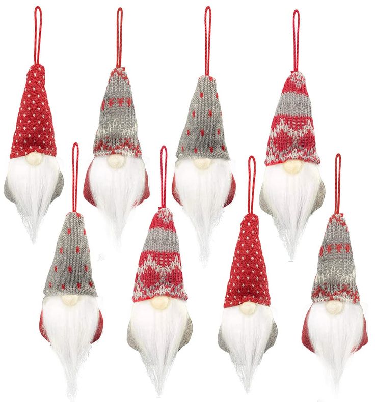 six christmas gnome ornaments hanging from red and white string with polka doted hats on them