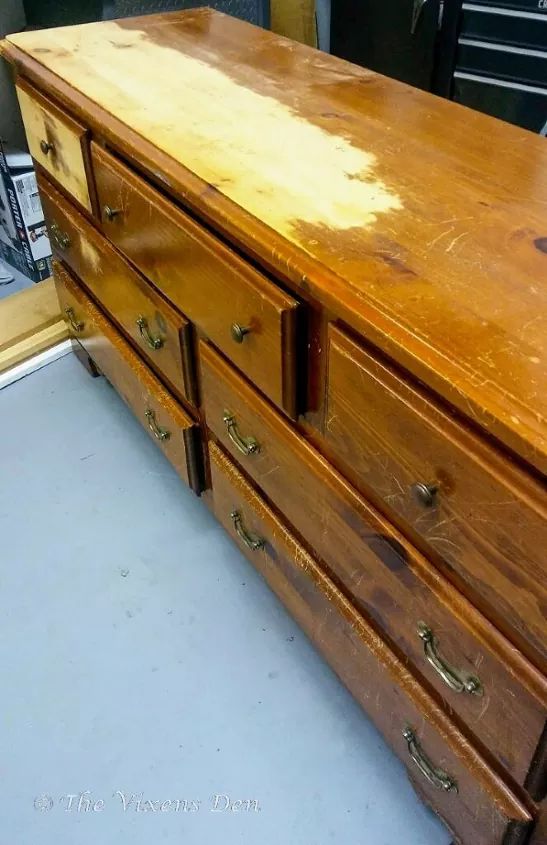 an old wooden dresser with some paint on it's top and bottom drawers missing