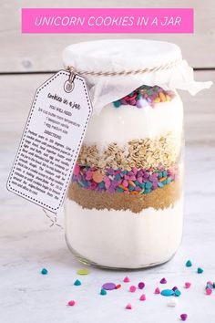 a jar filled with cookies and sprinkles on top of a table