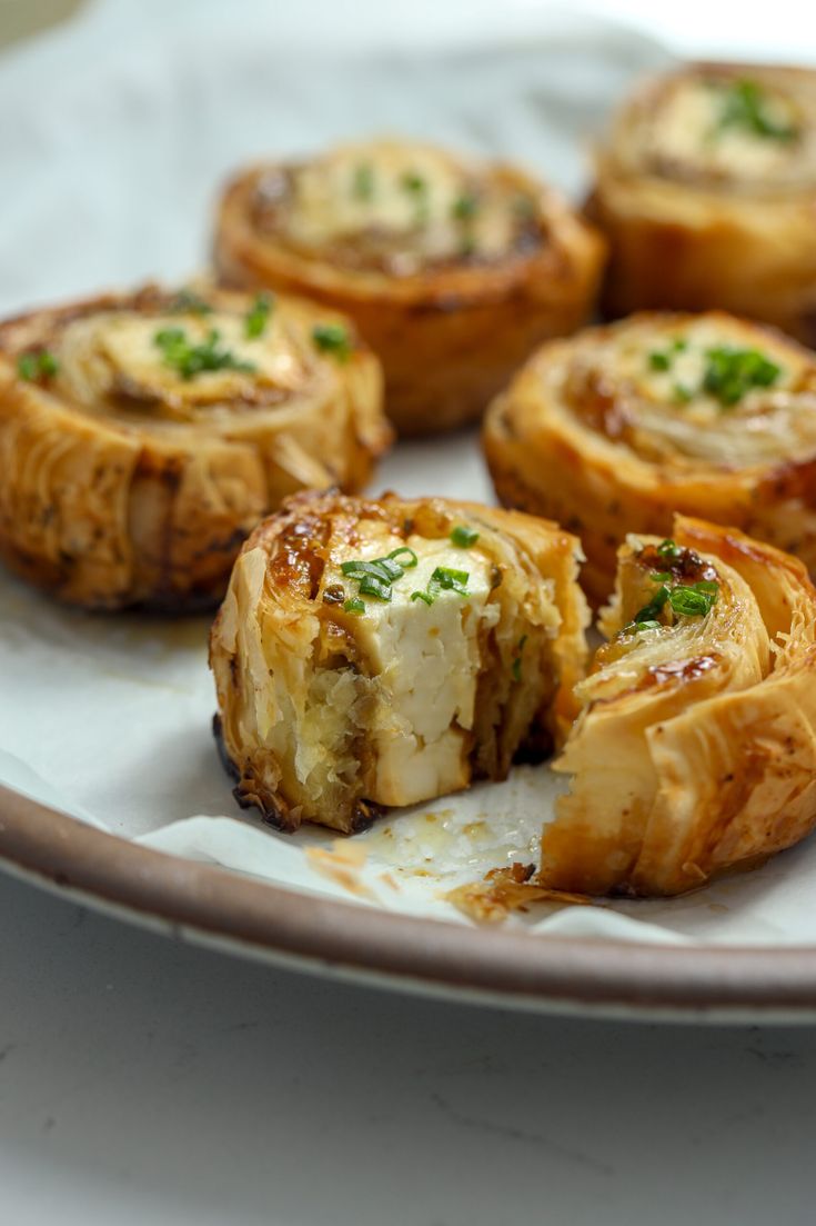 small pastries on a plate with parsley sprinkled around the edges, ready to be eaten