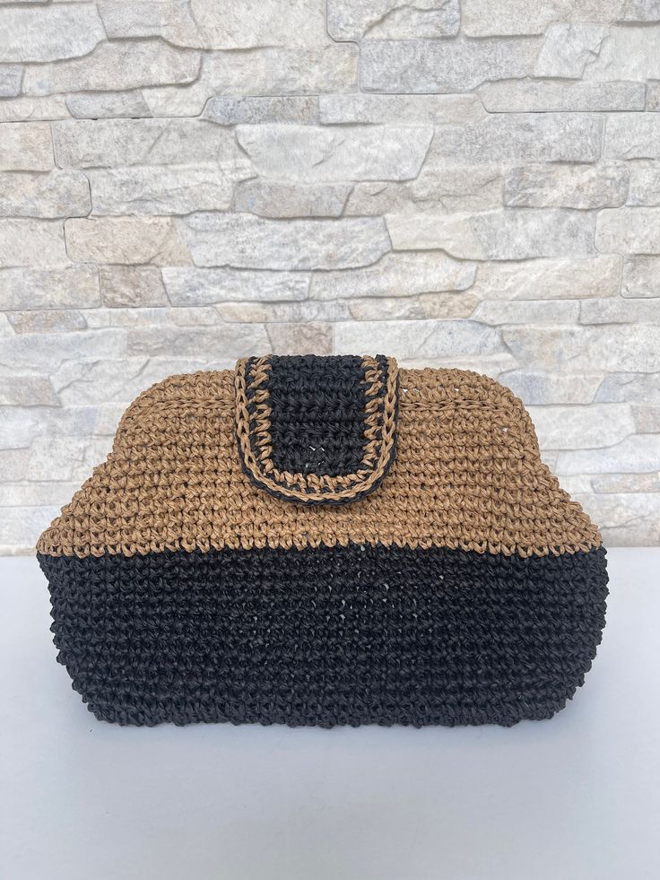 A beautiful handmade black and natural color crochet clutch bag made with natural raffia, lined with cotton fabric inside--closure with metal clips. With this unique and trendy design, our crochet clutch bag is a perfect accessory for any occasion. The clutch's compact size makes it easy to carry and perfect for holding your essentials, such as your phone, keys, and some makeup essentials. Order now and experience the beauty and luxury of our handmade knitted clutch bag! In case of several order Knitted Clutch, Boho Clutch Bag, Hand Knit Bag, Raffia Clutch, Crochet Clutch Bags, Boho Clutch, Knitted Bag, Dumpling Bag, Cloud Bag