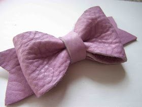 a pink bow with the word leather bow on it's front and bottom corner