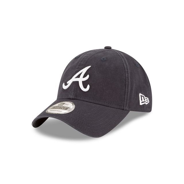 The Atlanta Braves Core Classic 9TWENTY Adjustable Cap features an embroidered Braves logo at the front panels with a woven tab displaying the team logo on a D-Ring closure at the rear. Sporty Logo Cap, Navy Hat With Embroidered Logo And Curved Visor, Sports Dad Hat With Embroidered Logo And Curved Brim, College Baseball Cap With Embroidered Logo, Classic Baseball Cap With Embroidered Logo For Sports, Navy Dad Hat With Embroidered Logo, Casual Baseball Cap With Logo Detail, Adjustable Cap With Logo Detail, Casual Cap With Logo Detail