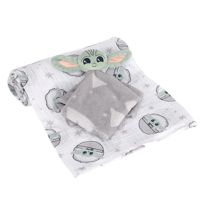 the baby yoda blanket is laying on top of it's back and has a gray