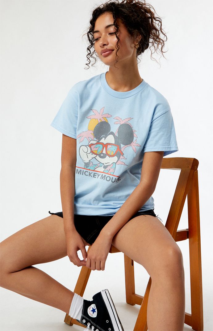 Online only! Who knew that dressing "mousey" could be so cute? Celebrate Walt Disney's most iconic character with these officially licensed Mickey Mouse and Friends styles! All of your favorites, like Mickey Mouse, Minnie Mouse, Goofy, Pluto, Donald Duck, and more, are featured across these adorable Mickey designs that are perfect for your next trip to Disneyland! The Beach Mickey Mouse T-Shirt features a crew neckline, short sleeves, and a front graphic for that classic look.&nbs Disney Style Tops For Summer Fan Events, Casual Graphic Print Tops For Disney Trips, Casual Mickey Mouse Tops With Relaxed Fit, Casual Crew Neck T-shirt For Disney Fan Events, Character Print Tops For Disney Fan Events In Summer, Summer Cartoon Print Tops For Disney Fan Events, Cute Tops For Disney Fan Events In Summer, Graphic Print Tops For Disney Fan Events In Summer, Character Print Tops For Summer Disney Fan Events