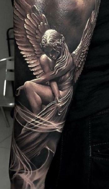 a tattoo with an angel sitting on top of it's arm and holding a baby