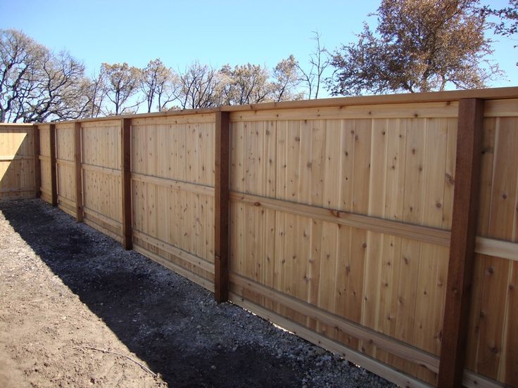 a wooden fence in the middle of a yard