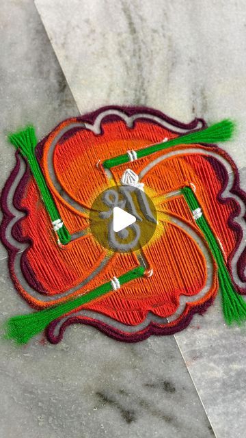 an orange flower with green leaves on it is embroidered onto the side of a piece of fabric