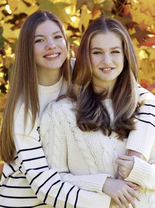 two girls are posing for the camera with their arms around each other