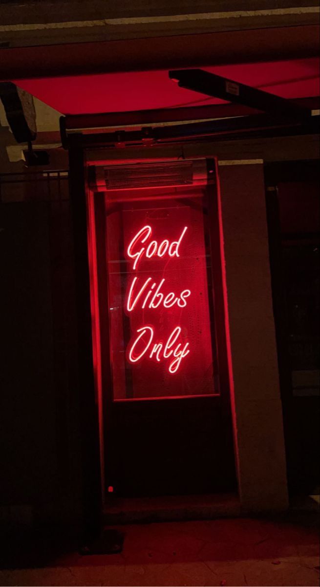 a red neon sign that says good vibes only