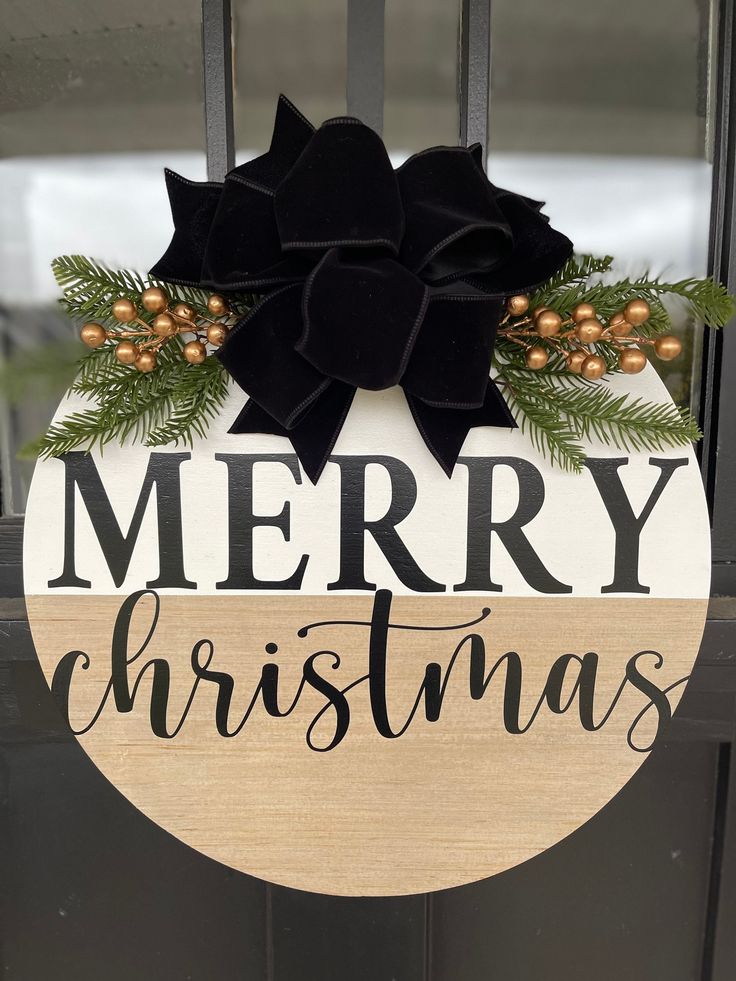 a merry christmas sign hanging on the front door