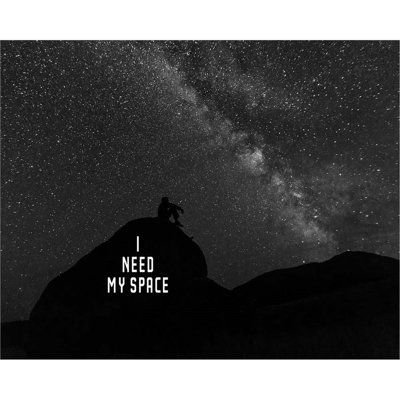 a man sitting on top of a mountain under the stars with text that reads i need my space