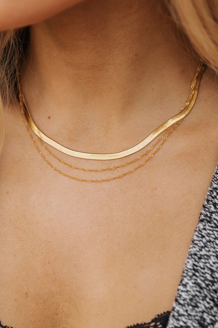 Make a statement with the chic and minimalist Gold Layered Choker Necklace! Featuring a herringbone design, this necklace offers a sleek, polished finish that adds texture and dimension to your style. The double-layered chain creates a stacked look, effortlessly elevating any outfit from simple to sophisticated. In a classic choker style, it sits beautifully around the neck, making it perfect for pairing with both casual and dressier outfits. Revival Clothing, Fall Style Guide, Gameday Dress, Layered Choker Necklace, Layered Chain, Herringbone Design, Layered Chokers, Casual White Dress, Concert Looks