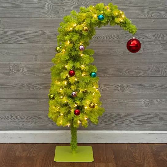 a green christmas tree with ornaments on it and a red ornament hanging from the top