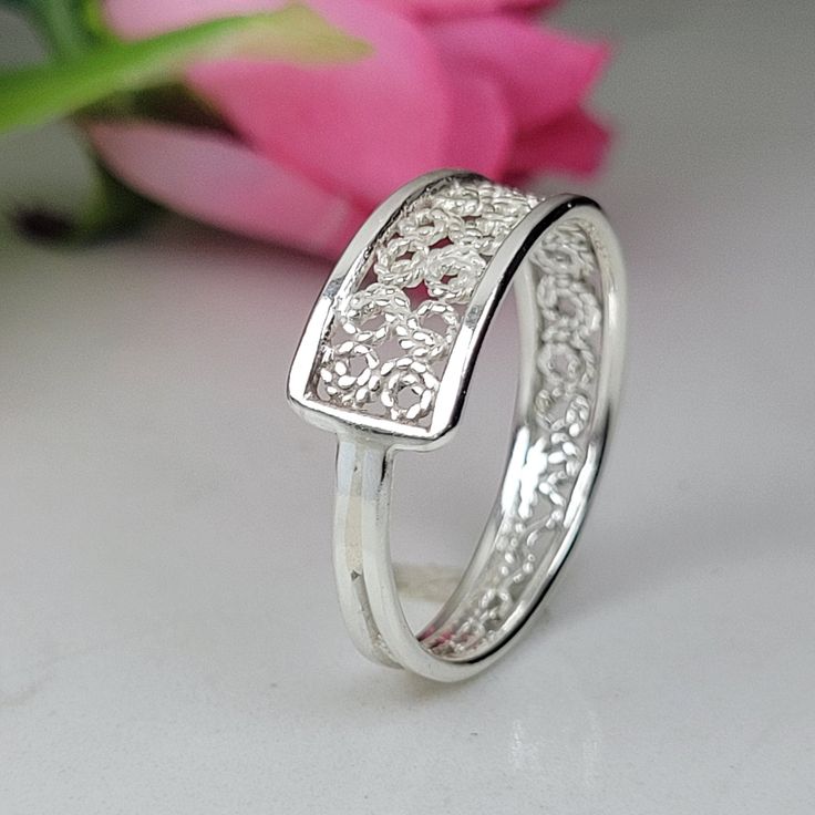 Filigree ring made by intricate metal work, creating a rich floral pattern and dainty look. The wide silver ring is inspired by the Art nouveau jewelry combined with modern design. This unique silver band is perfect for a beloved woman, and as a pampering gift for yourself. The ring is very flattering to the finger, comfortable to wear as a jewel for everyday use and impressive as a jewel for a special occasion. The ring has an asymmetric structure with a width that gradually changes from 7 to 3 mm approximately, creating an elegant and unique style. The ring is made of 925 sterling silver by hand tools only. Each piece of jewelry is handmade to order, therefor due to the special nature of handcrafting, there may be slight differences compared to the jewelry in the photos shown. This adds Silver Rings For Women Unique, Filigrana Jewelry, Modern Silver Jewelry, Wide Silver Ring, Chunky Silver Rings, Modern Jewellery Design, Handmade Silver Jewelry, Filigree Jewelry, Vintage Style Rings