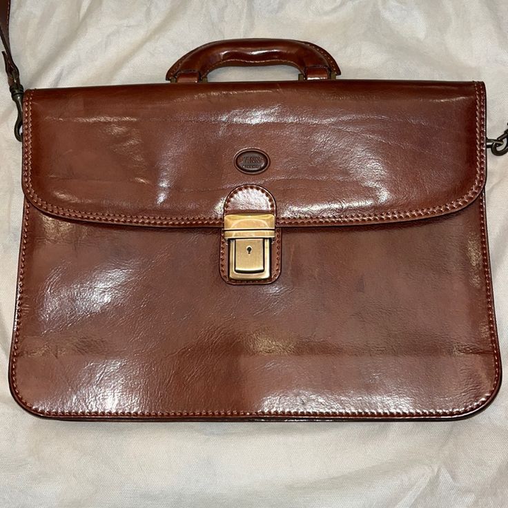 New Made In Italy Brown Genuine Leather Messenger Bag. 15” X 11”. Expandable 1 1/2” To 2 1/2”. Inside Divided Compartments, Zipper Pocket, Card And Pen Holder. Handle And Removable 18” Strap. Antique Brass Hardware With Closure And Key. Storage Bag Included. Purchased In Florence Italy. Designer Briefcase With Removable Pouch For Business, Designer Business Briefcase With Removable Pouch, Designer Brown Bags For Business Trips, Designer Brown Satchel For Business Trips, Designer Formal Shoulder Briefcase, Classic Brown Laptop Bag With Removable Pouch, Formal Satchel Laptop Bag With Removable Pouch, Classic Tote Shoulder Bag For Business Trips, Brown Formal Briefcase With Removable Pouch