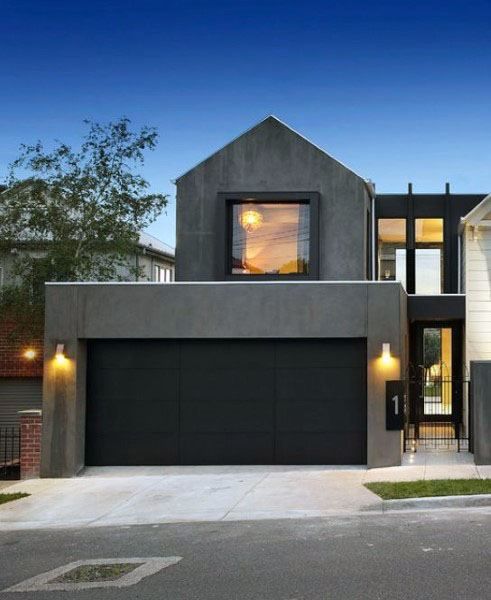 a modern house with two garages on the street