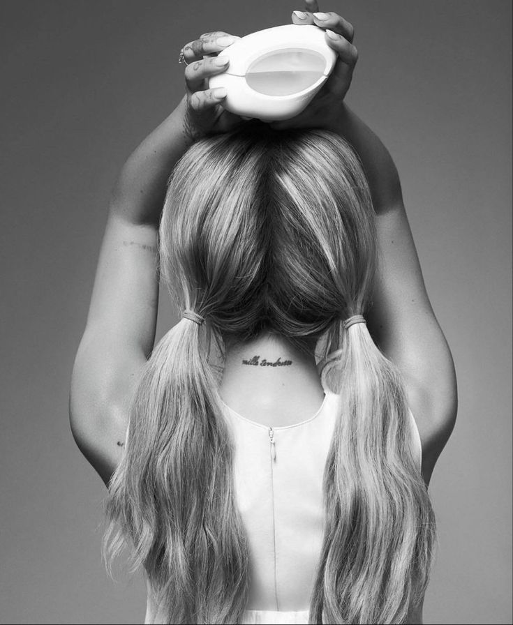 the back of a woman's head with long blonde hair