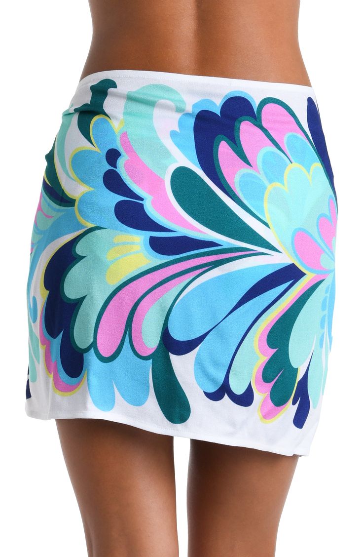 The print on this short pareo cover up features a bold and dynamic floral pattern with large, stylized petals in shades of blue, green, pink, and yellow, creating a modern and exuberant effect. The design has a flowing, organic quality to it, giving the impression of movement and radiance. The one-size-fits-all design provides a custom fit, and the side tie keeps everything undercover. [split] Details Short pareo cover up Adjustable wrap tie Tassel trim One size fits all Fabric 100% Rayon Crepe Multicolor Tropical Print Sarong For Poolside, Multicolor Tropical Print Beachy Sarong, Beachy Multicolor Sarong With Tropical Print, Beachy Multicolor Tropical Print Sarong, Multicolor Tropical Print Sarong For Pool, Multicolor Tropical Print Sarong For Beachwear, Tropical Multicolor Sarong For Poolside, Green Printed Sarong For Spring, Beachy Multicolor Printed Sarong