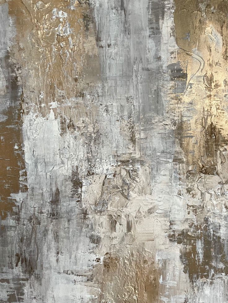 an abstract painting with gold, silver and white colors on it's surface is shown