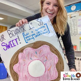 a woman holding up a sign that says, your behavior is so sweet and there's donuts in front of her