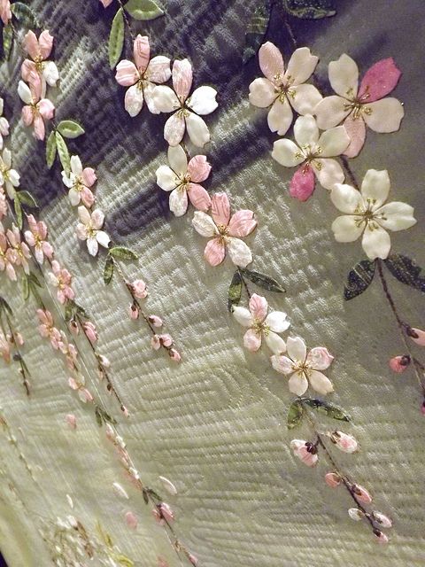 the wall is decorated with pink and white flowers