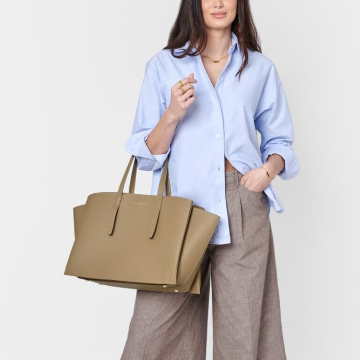 Designed to enhance your daily routine, our Tabi Large Tote Bag in Taupe features a spacious interior that accommodates most laptop models, making it perfect for both casual and professional occasions. It also includes a removable zip pouch suitable for devices up to 13 inches, along with a D-ring for personalizing with Clip-On Accessories. Pebble vegan leather design with soft suedette lining Features shoulder straps, 3 internal compartments, removable pocket pouch, and internal D-ring for Clip Workwear Laptop Bag With Top Handle And Removable Pouch, Top Handle Laptop Bag With Removable Pouch For Work, Large Capacity Double Handle Laptop Bag For Work, Workwear Laptop Bag With Removable Pouch And Double Handle, Workwear Laptop Satchel With Removable Pouch, Workwear Satchel With Laptop Sleeve In Tote Shape, Workwear Shoulder Laptop Bag With Removable Pouch, Workwear Laptop Shoulder Bag With Removable Pouch, Workwear Tote Shoulder Bag With Laptop Sleeve