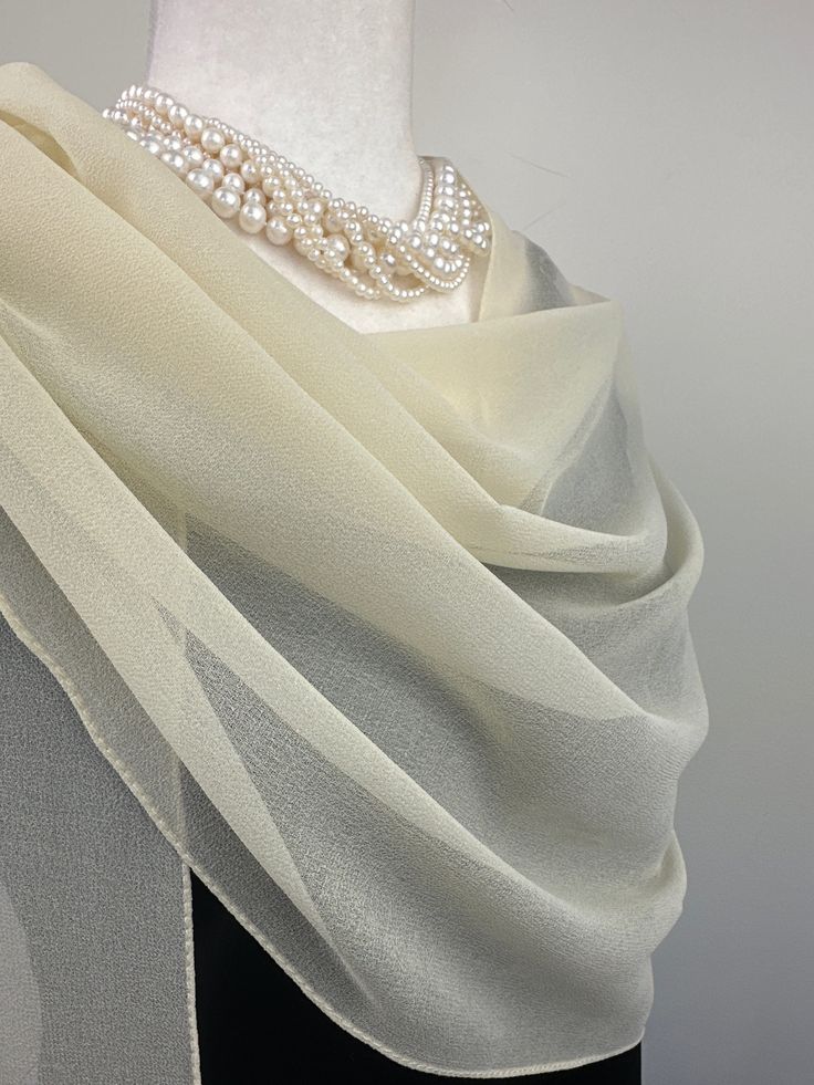 Elevate your style with our exquisite collection of chiffon shawls. Our chiffon shawls are the epitome of elegance and versatility, designed to effortlessly enhance your wardrobe and leave a lasting impression. Made from the fine poly chiffon fabric, these shawls offer a delicate and airy drape that adds a touch of grace to any outfit. Whether you're attending a special occasion, a casual gathering, or simply want to elevate your everyday look, our chiffon shawls are the perfect accessory. Choos Elegant Cream Party Veil, Elegant White Formal Veil, Classic Gold Silk Scarf For Formal Occasions, Elegant Cream Scarf For Formal Occasions, Elegant White Evening Veil, Chiffon Silk Scarf For Weddings, Elegant White Pashmina Shawl, Elegant Sheer Dupatta For Formal Occasions, Cream Dupatta Scarf For Wedding