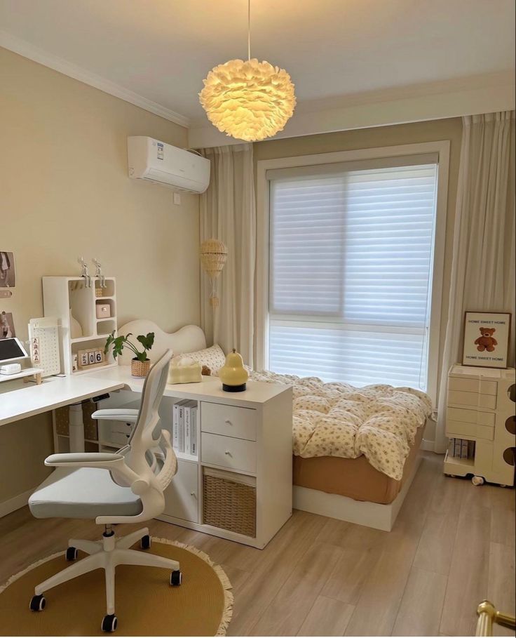 a bedroom with a bed, desk and chair in it next to a large window