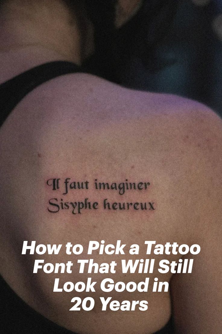 Gabby Pignanelli posing with her back to the camera showing off her tattoo that states, "If fault imaginer sysphe heureux." Script For Tattoos Lettering, Text Based Tattoos, Where To Put Writing Tattoos, Tattoo Word Ideas Female, Font Ideas Tattoo, Lowercase Tattoo Font, Unique Lettering Tattoo, Old Font Tattoo, Best Font For Tattoo Lettering