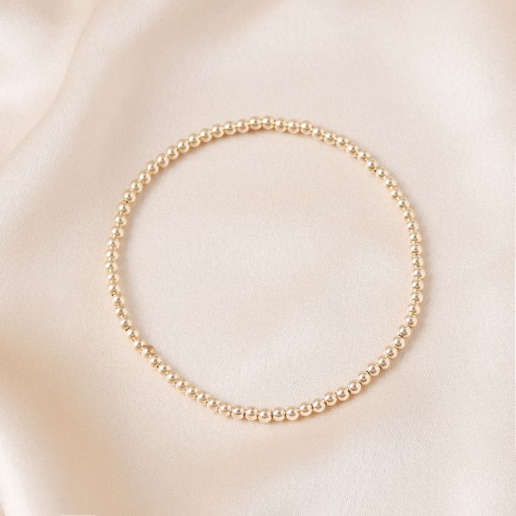 This stretchy gold ball bracelet is made of 14k gold filled beads, and is the perfect addition to any outfit. Whether you're dressing up for a special occasion or just want to add a touch of luxury to your everyday look, this bracelet is sure to make a statement. Swim, sweat, and sleep in it without a worry in the world. Elegant Gold Stretch Bracelet, Gold 14k Gold-filled Round Beads Pearl Bracelet, Classic Gold Beaded Bracelets In 14k Gold Filled, Classic Gold Beaded Stretch Bracelet, Gold 14k Gold-filled Pearl Bracelet With Round Beads, Elegant 14k Gold-filled Bracelets With 8mm Beads, Elegant 14k Gold-filled 8mm Beaded Bracelets, Elegant Rose Gold Stretch Bracelet For Daily Wear, Elegant Rose Gold Stretch Bracelet For Everyday