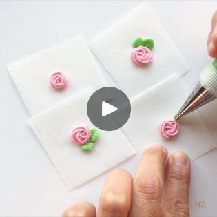 someone is making small pink roses out of fondant and paper with a crochet hook