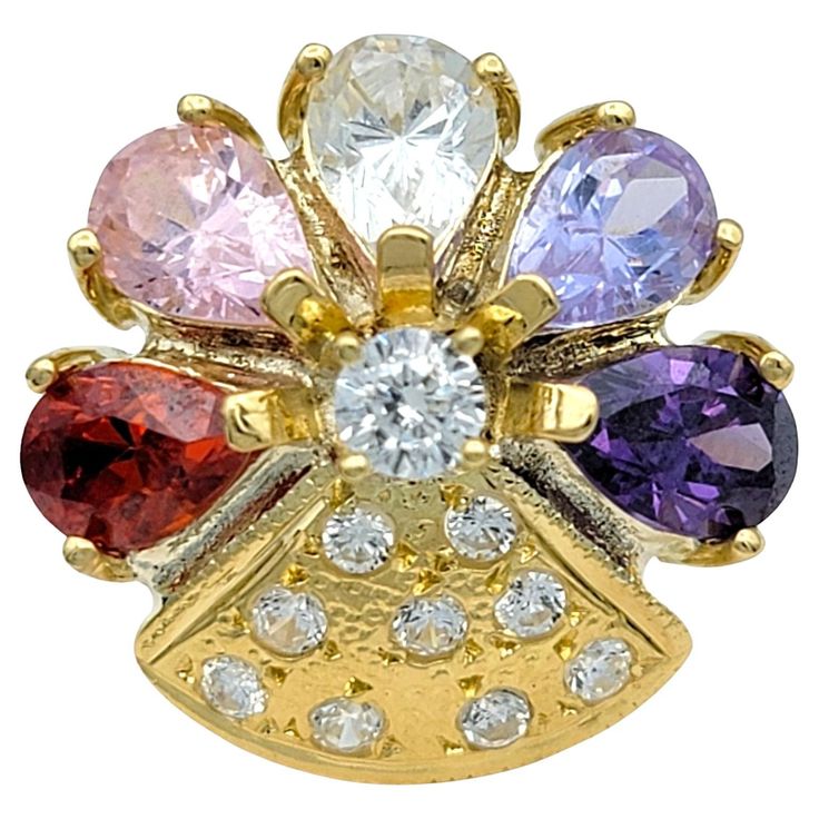 Ring Size: 7 Illuminate your style with this colorful gemstone and diamond cocktail ring, exquisitely crafted in 18 karat yellow gold. This stunning ring features an enchanting flower design, adorned with a vibrant array of multi-colored gemstones. Each petal gleams with its unique hue, creating a kaleidoscope of color that captivates and delights. Sparkling diamonds accentuate the center and bottom of the flower, adding a touch of brilliance and elevating the ring’s luxurious appeal. The rich y Yellow Gold Cocktail Ring, Diamond Flower Pendant, Gold Flower Ring, Colored Gemstones, Diamond Cocktail Ring, Gold Cocktail Ring, Gold Cocktail, Diamond Cocktail Rings, Diamond Flower