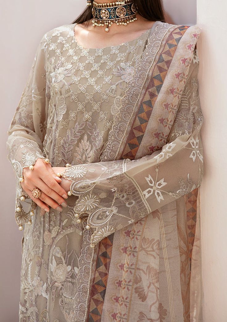 Introducing our Chiffon collection DASTAN by Ramsha designed to make you look and feel your best These pieces will add a touch of class and elegance to your wardrobe. This collection is a beautiful collection of ensembles offering versatile compositions for the latest festive wardrobe requirements. Embroidered Chiffon Front With Sequence. Embroidered Chiffon Back and Sleeves. Embroidered Organza Lace. Embroidered Organza Ghera, and Trouser Lace. Embroidered Net Dupatta. Raw Silk Trouser. Color: There might be slight color variation due to lighting and flashes while the photo shooting. The color may also vary because of different screen resolutions. Wash Care: Dry Clean Only. Velvet Anarkali, Batik Print Dress, Salwar Suits Party Wear, Indian Anarkali, Lehenga Jewellery, Saree Sale, Organza Lace, Velvet Shawl, Lehenga Style