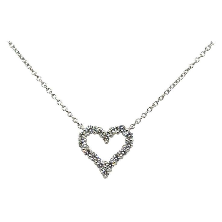 Elegant Tiffany & Co. diamond heart pendant necklace crafted in 950 platinum. The necklace showcases a heart shaped pendant set with 16 round brilliant cut diamonds that show F color with Vs clarity. The pendant is set with 0.25 carat of earth mined natural diamonds. This iconic heart shape is synanomous with the brand and been a staple for years. The necklace measures 17.25" in length and is fully hallmarked on by the designer on both the chain and pendant. The necklace has been recently polish Heart-shaped White Gold Solitaire Necklace With Diamond Accents, White Gold Heart Solitaire Necklace With Diamond Accents, Heart-shaped Diamond Solitaire Necklace With Accents, Classic Diamond White Necklace With Heart Charm, Round Cut Diamond Necklace With Heart Charm, Diamond Necklaces With Heart Charm And Round Cut, Diamond Heart Charm Necklaces With Round Cut, Diamond White Solitaire Necklace With Heart-shaped Diamond Accents, Diamond White Heart Solitaire Necklace With Accents