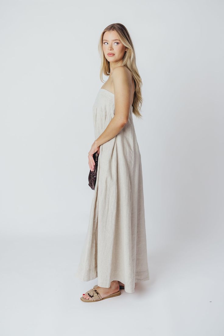 Expertly crafted from premium-quality linen, the Zabina Maxi Dress offers a stylish and comfortable option for all your warm-weather activities. This gem is lightweight, ultra-comfortable, and thanks to its removable straps, a beautifully versatile addition to your wardrobe. FIT: Runs true to size - relaxed fit. MATERIAL: 100% Linen. GARMENT DETAILS: Relaxed maxi dress in 100% linen, with removable spaghetti straps. Features dual in-seam pockets, with a back button closure and gently-defined empire waist. SIZE GUIDE: S (2-4) / M (6-8) / L (10-12) MODEL DETAILS: Heather is wearing size S. Mackenzie - Size S Heather - Size S Molly - Size XL Our Brunette Misses Model Our Blonde Misses Model Our Blonde Curve Model Bust 34" 34" 37" Waist 27.5" 27.5" 32" Hips 40.5" 37.5" 47" Height 5'7" 5'7" 5'7 Linen Sundress Maxi Dress For Daywear, Linen Sundress For Daywear, Vacation Linen Maxi Dress, Maxi Linen Dress For Vacation, Maxi Length Linen Dress For Vacation, Linen Maxi Dress For Spring, Spring Maxi Linen Dress, Beach Linen Maxi Dress With Adjustable Straps, Beige Linen Dress For Beach