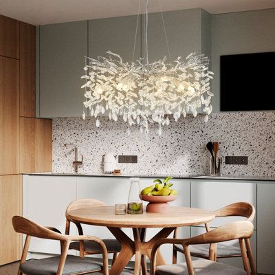 a dining room table with four chairs and a bowl of fruit on top of it