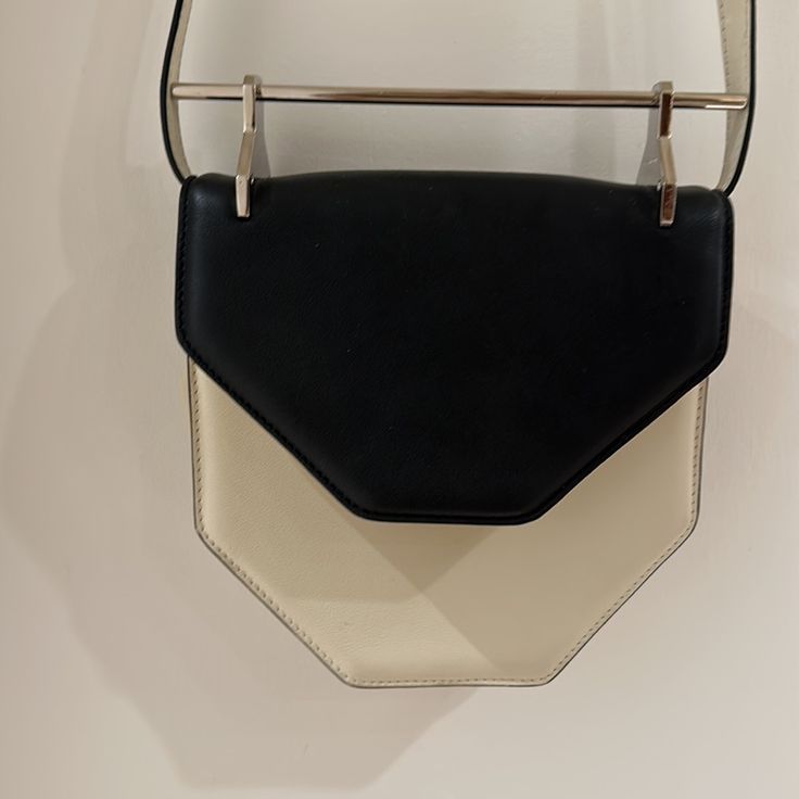 Rare Black And Ivory M2malletier Leather Handbag With Metal Handle Makes For The Coolest Evening Bag In Its Hexagonal Shape. Magnetic Clasp And Pockets Inside. In Pristine Condition Designer White Flap Bag For Evening, Designer White Flap Bag For Formal Occasions, Cream Rectangular Flap Bag For Evening, Modern Cream Rectangular Flap Bag, Cream Top Handle Box Bag For Evening, Modern White Satchel Flap Bag, Designer White Clutch With Top Handle, Modern Cream Box Bag With Detachable Handle, Designer White Top Handle Clutch