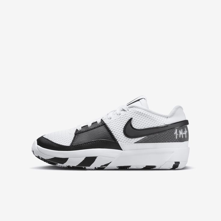 a white and black sneaker with the word nike written on the upper part of the shoe