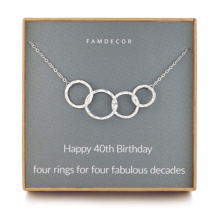 a silver necklace with three circles on it in a gift box that says, happy birthday four rings for four fabulous decades