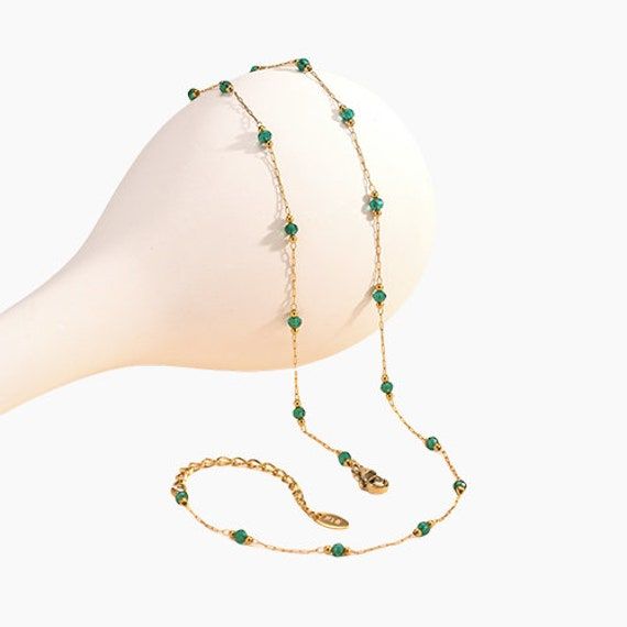 Elevate your jewelry collection with our exquisite Dual-Color 18K Gold-Plated Crystal Bead Necklace. This elegant piece features a stunning combination of vibrant emerald and deep black crystals, interspersed with gleaming gold beads. Choose between the lush greens of emerald or the bold allure of black for a versatile accessory that adds a touch of luxury to any look. Key Features: - 18K Gold Plating: Each necklace is meticulously plated with 18K gold for a rich, long-lasting shine. - Premium Crystals: Hand-selected emerald and black crystals ensure maximum sparkle and clarity. - Interspersed Design: Gold beads are strategically placed between crystal beads for a visually striking effect. - Versatile Choice: Perfect for both formal events and everyday wear, this necklace is a timeless add Gold Plated Green Emerald Necklace, Gold Emerald Necklaces With Gemstone Beads, Green Round Gold Plated Emerald Necklace, Green Emerald Necklace With Adjustable Chain, Green Round Emerald Gold Plated Necklace, Round Green Emerald Gold Plated Necklace, Round Green Emerald Gold-plated Necklace, Elegant Emerald Necklace With Beaded Chain, Green Jewelry With Round Beads And Adjustable Chain