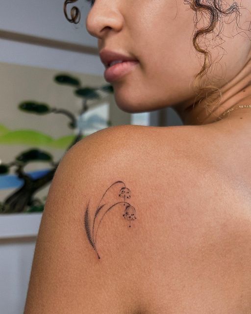 a woman with a tattoo on her shoulder