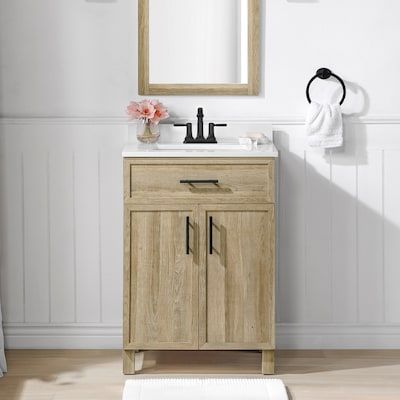 a bathroom with a sink, mirror and towel rack