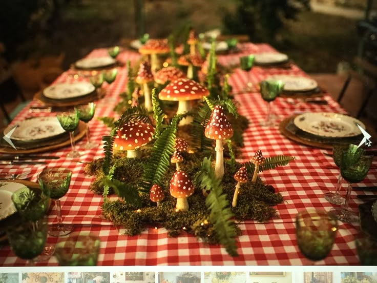 an image of a table setting with mushrooms and ferns