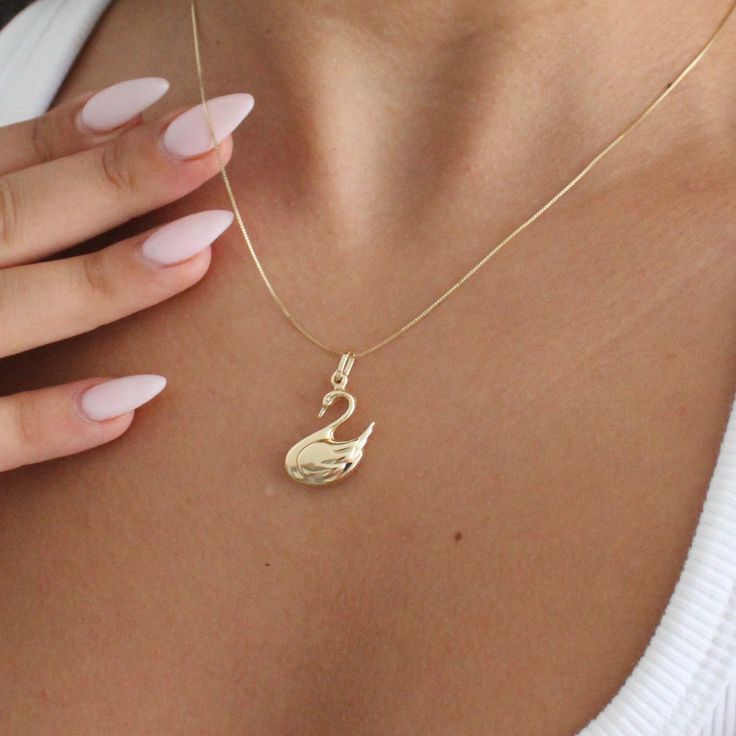 "14K Solid Gold Swan Necklace . . . * Pendants Measurements With Bail: (30 x 15 mm) * Chain is included ( 1MM Box Chain) * Stamp: Real 14k Gold * Never gold filled or plated * Hypoallergenic * Water Resistant * Scratch Resistant * Packaged With Free Gift Box . . . If you have any questions, just hit the \"Message the Seller\" button ( bottom right of the page) and we will get back to you within a few hours. . . . Mailed in a cute white package great for gifting. . . . Check our Social Media @Talajewel, and let's be friends! . . . . Made in USA, Swan Jewelry, Gift for animal lovers, Gift for bird lovers, Gold Swan Necklace, Swan Necklace, Necklace Charm, Can be worn with other necklaces, great for layers. A Perfect 14K Gold gift. Christmas Gift, Christmas gift for her, Christmas gift for hi 14k Gold Charm Necklace With Box Chain, 14k Yellow Gold Charm Necklace With Box Chain, 14k Gold Box Chain Necklace For Anniversary, Gold Plated Curb Chain Charm Necklace Gift, 14k Gold Jewelry With Curb Chain For Gift, 14k Gold Snake Chain Necklaces With Diamond Cut, Gold Charm Necklace With Box Chain For Anniversary, 14k Rose Gold Snake Chain Necklace, Diamond Cut Snake Chain Necklace For Gift