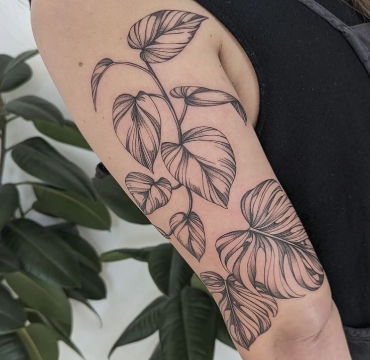 a woman's arm with leaves on it