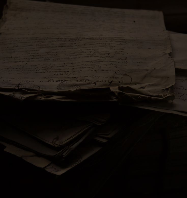 a pile of papers sitting on top of a wooden table