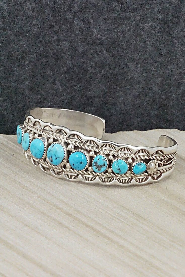 This Kingman turquoise and sterling silver bracelet was made by Navajo silversmith Anthony Brown. The inside is signed Anthony B and stamped sterling.Size: 5 3/8" (will fit up to a 6 3/8" wrist)Gap: 1"Width: 3/4"Free shipping on all orders! We ship with USPS and always include tracking. All orders ship within a day of payment.Returns are accepted up to 30 days after you receive your order. Just send us a message. Our shop offers cash back or store credit. The item must be returned in new conditi